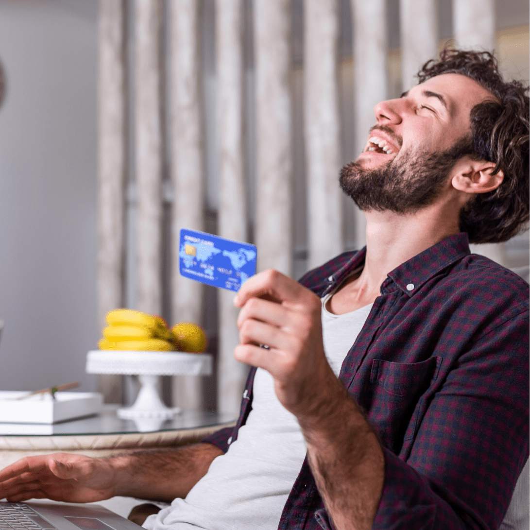 Online Shopping (2)-min A smiling man using SanctusPay payment processing while online shopping